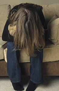 Woman hiding in a cushion