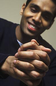 Man looks down at hands