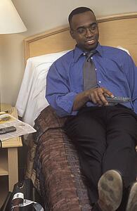Businessman watching television in hotel room