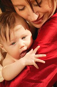 Mother holds baby in arms