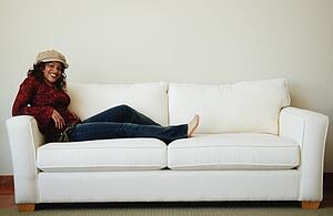 Woman relaxes on sofa
