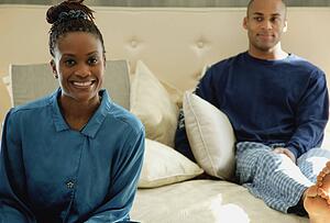 Couple relaxes on bed