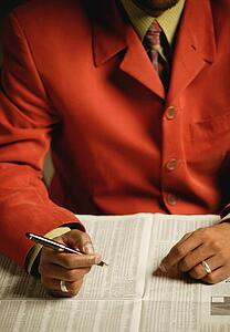 Businessman looks at the newspaper