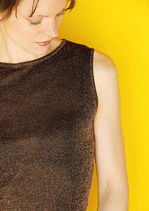 Female modeling brown sleeveless top
