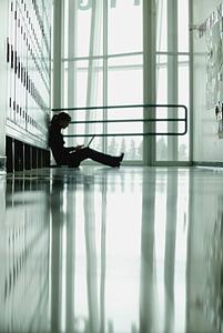 Student sitting by lockers