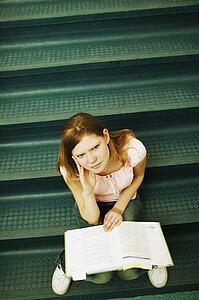 Student studying on stairs