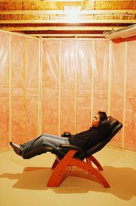 Man listens to music in unfinished room