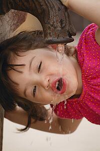 Girl drinking from water fountain