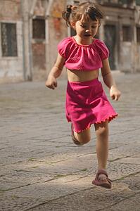 Girl running through street
