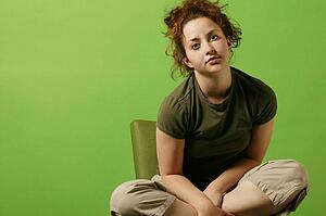 Teenage girl sits in a chair