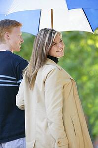 Young couple with umbrella