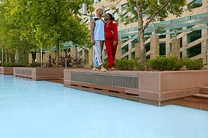 Couple takes a walk beside a pool
