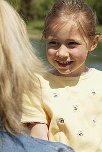Girl smiles at mother