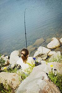 Child fishing on a beach