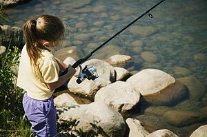 Child fishing on a beach