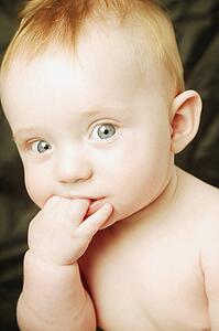 Baby chews on fingers