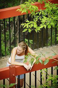 Woman relaxes on a bridge