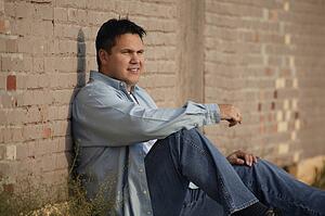 Man leans against wall