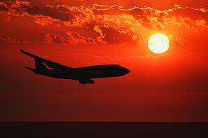 Airplane flying during sunrise/sunset