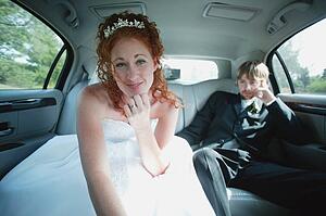 Bride leans forward in car
