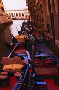 Gondolas in canal side street in Venice Italy Europe