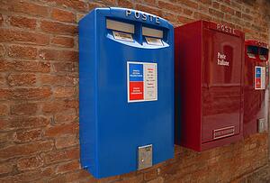 Italian mailboxes hanging on a brick wall in Italy Europe
