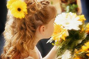 Flower girl smells bouquet