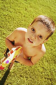 Child plays with water gun
