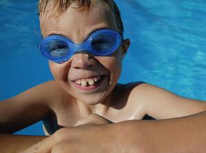 Child smiles in the swimming pool
