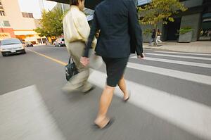 Businesspeople cross the street