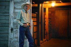 Cowboy stands by door
