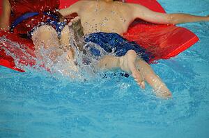 Two children splash in the pool