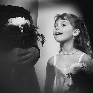 Flower girl peeks at the bride