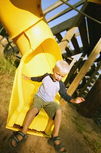 Boy goes down a slide