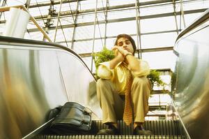 Man sits on an escalator