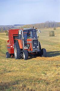 Tractor makes bales of hay