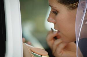 Bride adjusts lipstick