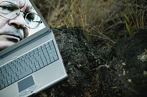 Man's face on laptop computer