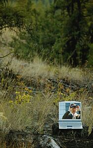 Man with binoculars in field