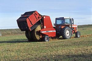 Tractor making bales