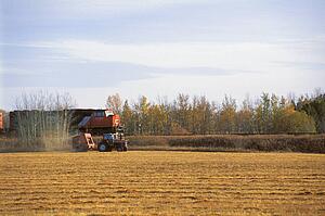 Tractor beside a train