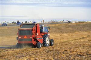 Tractor working beside highway