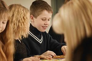 Kids play at a table together
