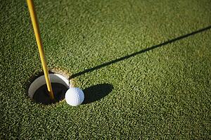 Golf ball close to pin