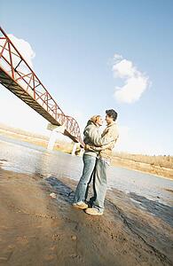 Couple embrace in river valley