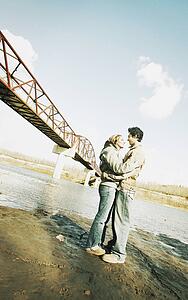 Couple embrace in river valley