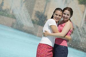 Two girls hug