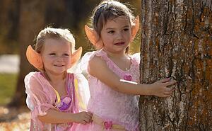 Two little elves waiting in the Autumn forest