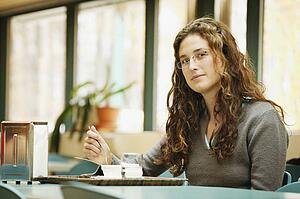 Woman eats in a cafeteria