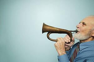 Profile of man playing horn